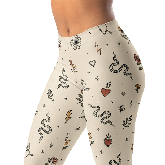 Minimal tattoo flash leggings with tiny suns, hearts, snakes, flowers, and lightning bolts