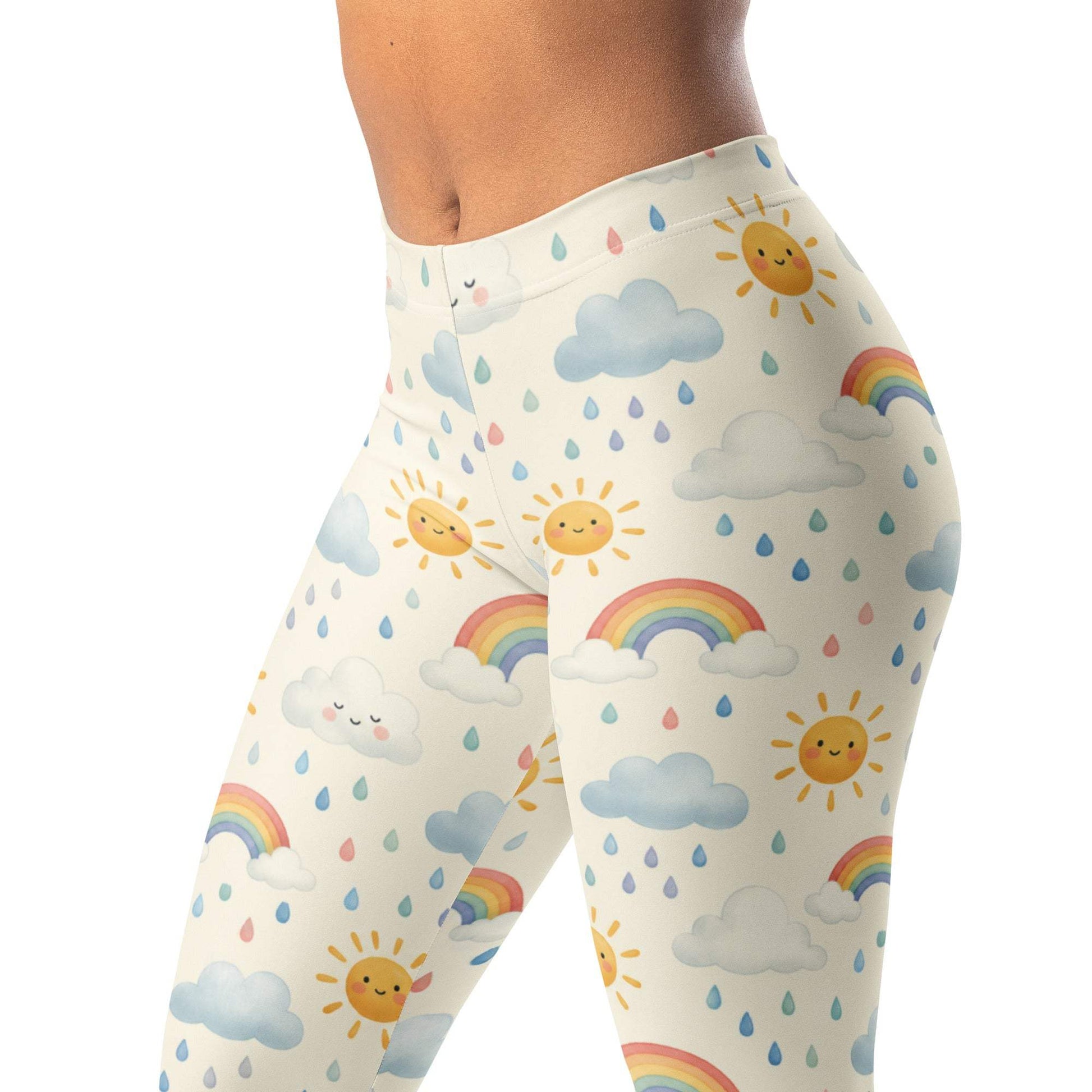 Sun shower leggings with playful sun, rain, and rainbow design on soft cream background